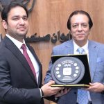 President Chamber of Commerce, Khawar Hussain Sapal, is presenting a souvenir to Provincial Minister for Energy, Sports, and Youth Affairs, Faisal Ayub Khokhar, at SCCI