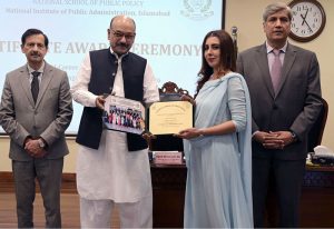 Secretary, Establishment Division, Barrister Nabeel A. Awan presents certificates to participants during the passing-out ceremony of the 47th Mid-Career Management Course at NIPA