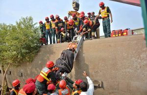 Rescue workers evacuate an injured passenger from a coach after 14 coaches of the Karachi–Peshawar-bound Rehman Baba Express derailed near Sher Shah Railway Station at least four passengers were killed and 49 injured in the incident.