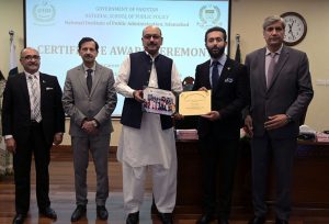 Secretary, Establishment Division, Barrister Nabeel A. Awan presents certificates to participants during the passing-out ceremony of the 47th Mid-Career Management Course at NIPA