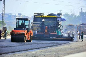 A view of construction work on a new road with heavy machinery at Boulevard Mall Road during development work in the city.