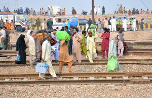 Rescue workers evacuate an injured passenger from a coach after 14 coaches of the Karachi–Peshawar-bound Rehman Baba Express derailed near Sher Shah Railway Station at least four passengers were killed and 49 injured in the incident.