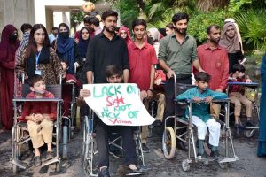 Participants march during an awareness walk organized by the Eilya Care Foundation to mark World White Cane Safety Day at D-Ground Chowk.