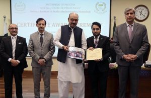Secretary, Establishment Division, Barrister Nabeel A. Awan presents certificates to participants during the passing-out ceremony of the 47th Mid-Career Management Course at NIPA