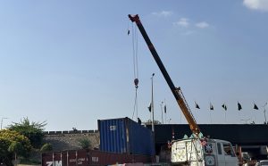 A crane lifts a container as authorities remove containers from the entry and exit routes of Federal Capital, on the administration’s orders.