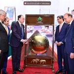 Federal Minister for Finance and Revenue Senator Muhammad Aurangzeb rings the gong during a ceremony at the Trading Hall of the Pakistan Stock Exchange (PSX)