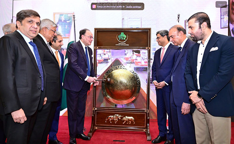 Federal Minister for Finance and Revenue Senator Muhammad Aurangzeb rings the gong during a ceremony at the Trading Hall of the Pakistan Stock Exchange (PSX)