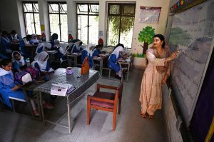 A teacher performs her duties at a government school as the world observes World Teachers’ Day, highlighting the vital role of teachers in education and the development of society.