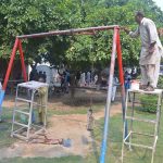 Workers busy in maintenance work of a swing installed near Divisional Public School at Club Road