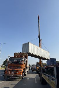 A crane lifts a container as authorities remove containers from the entry and exit routes of Federal Capital, on the administration’s orders.