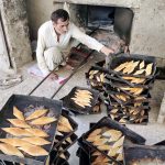 A worker busy in work at a local bakery near Rahmat Pur