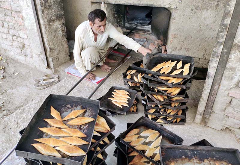 A worker busy in work at a local bakery near Rahmat Pur