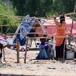 A gypsy woman prepares her hut in the Makki Shah area