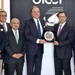 Federal Minister for Finance and Revenue Senator Muhammad Aurangzeb receives a souvenir during a meeting at the Overseas Investors Chamber of Commerce and Industry (OICCI) office