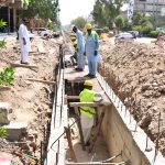 Labourers constructing a work on the drain as part of development work on Autobahn Road