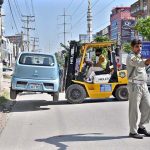 A wrongly parked car being lifted with the help of a lifter on PWD Road; a special operation against illegal parking is currently underway
