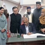 President of the Republic of Maldives Dr. Mohamed Muizzu writing his remarks in the visitors' book during his visit to the Faisal Mosque