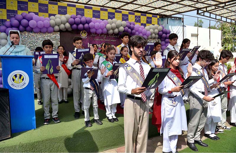 Report: Head of The City School University Town Campus Mariam Khalid administers the oath to students during an investiture ceremony at the campus in the city