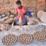 A craftsman preparing oil lamp in connection with upcoming Hindu festival Dewali at his work place near Jamshoro road