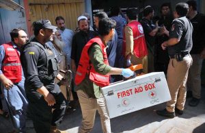 An ambulance shifting injured student and the bodies of several victims to hospital following a school roof collapse in Dir Colony.