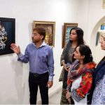 Visitors view calligraphy artworks at an exhibition organized by the Arts and Culture Forum (ACF) and the University of Home Economics in connection with the International Conference on Art and Design at Coopera Art Gallery, Mall Road