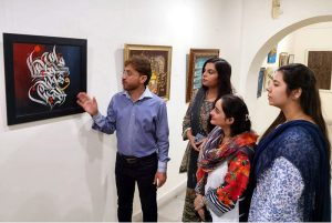 Visitors view calligraphy artworks at an exhibition organized by the Arts and Culture Forum (ACF) and the University of Home Economics in connection with the International Conference on Art and Design at Coopera Art Gallery, Mall Road
