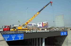 Workers install drainage pipes along Ring Road as part of ongoing development work to improve the city’s drainage system