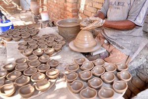 A craftsman preparing oil lamp in connection with upcoming Hindu festival Dewali at his work place near Jamshoro road