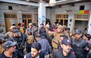 An ambulance shifting injured student and the bodies of several victims to hospital following a school roof collapse in Dir Colony.