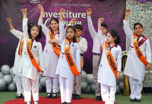 Head of The City School University Town Campus Mariam Khalid administers the oath to students during an investiture ceremony at the campus in the city