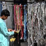 A young man is selecting mobile phone cables on Hall Road
