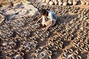 A craftsman preparing oil lamp in connection with upcoming Hindu festival Dewali at his work place near Jamshoro road
