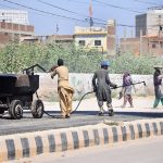 Workers engage in road construction as part of ongoing development activities on Autobahn Road