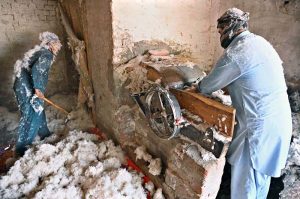 A worker prepares cotton at his workplace to fill quilts in the Factory Area
