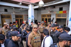 Rescue 1122 worker busy in rescue operation of the roof of a school building caved in, killing 33 children and a female teacher here at Dir Colony.