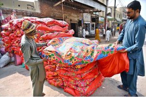 A worker prepares cotton at his workplace to fill quilts in the Factory Area