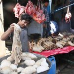 A young vendor is selling goat heads and trotters at his shop in the Provincial Capital