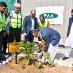 Federal Minister for Energy Sardar Awais Ahmad Khan Leghari is planting a sapling at the Sardar Farooq Ahmad Khan Legari Airport