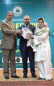 Javed Iqbal Mirza, Director General Federal Education giving away books to students during 3rd International Seerat Festival, “International Seerat Conference”.