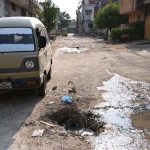 An uncovered open manhole poses a safety hazard to residents in Kachi Basti, requiring the attention of the concerned authorities