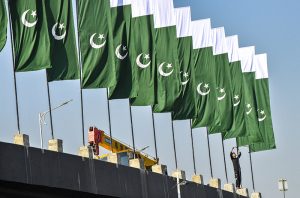 A CDA worker installs the national flag at Rawal Dam Chowk as the federal capital prepares to host the ECO Council of Foreign Ministers meeting on November 15–16.