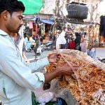 A street vendor sells Nuts Chikki, a traditional winter sweet made from nuts and sesame seeds