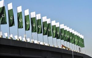 A CDA worker installs the national flag at Rawal Dam Chowk as the federal capital prepares to host the ECO Council of Foreign Ministers meeting on November 15–16.