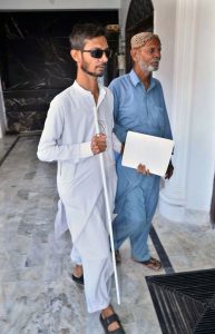 A visually impaired person walks with a white cane at a training center for people with visual impairments ahead of International White Cane Safety Day, observed.