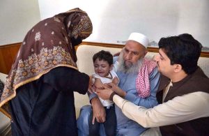 A child aged four months to 10 years receive fractional IPV booster doses, while those aged five months to 10 years are administered oral polio vaccine during an anti-polio campaign.