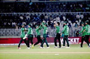 Cricket teams of Pakistan and Sri Lanka stand at attention as their national anthems are played before the start of the T20 International cricket match between the two sides at Rawalpindi Cricket Stadium.