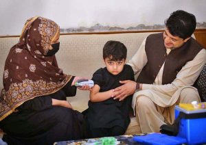 A child aged four months to 10 years receive fractional IPV booster doses, while those aged five months to 10 years are administered oral polio vaccine during an anti-polio campaign.