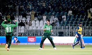 Cricket teams of Pakistan and Sri Lanka stand at attention as their national anthems are played before the start of the T20 International cricket match between the two sides at Rawalpindi Cricket Stadium.