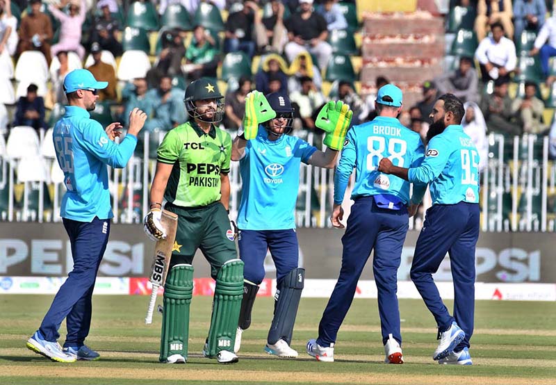 England players celebrate the dismissal of Pakistani batter Salman Ali Agha during the ODI Tri-Nation Series match between Pakistan and England at Rawalpindi Cricket Stadium