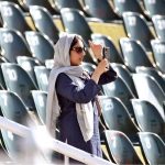A spectator capturing the moment with her cell phone during the ODI Tri-Nation Series cricket match between England and Sri Lanka at Rawalpindi Cricket Stadium